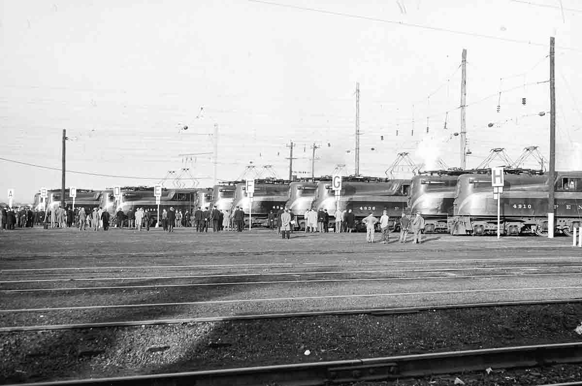 A distant shot of people boarding trains