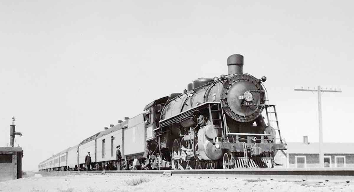 a steam engine with passenger cars