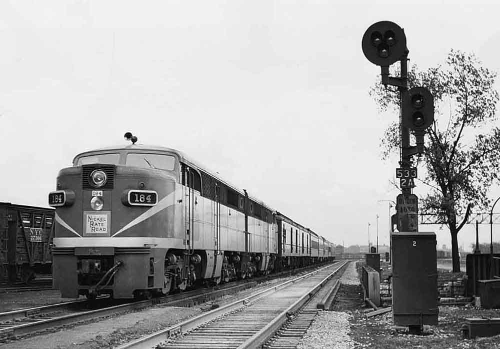 A train parked outside a stoplight