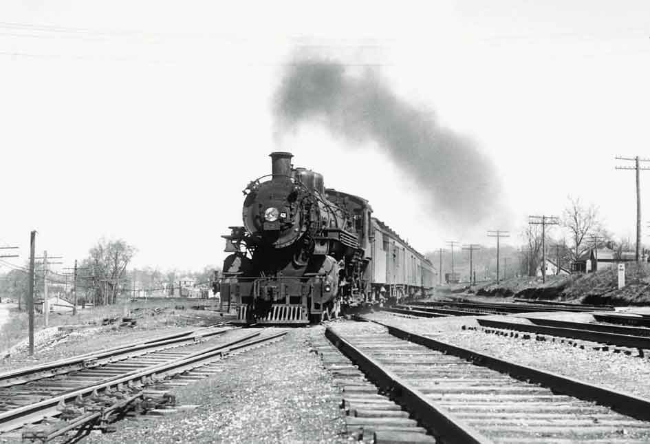 a steam engine pulling passenger cars