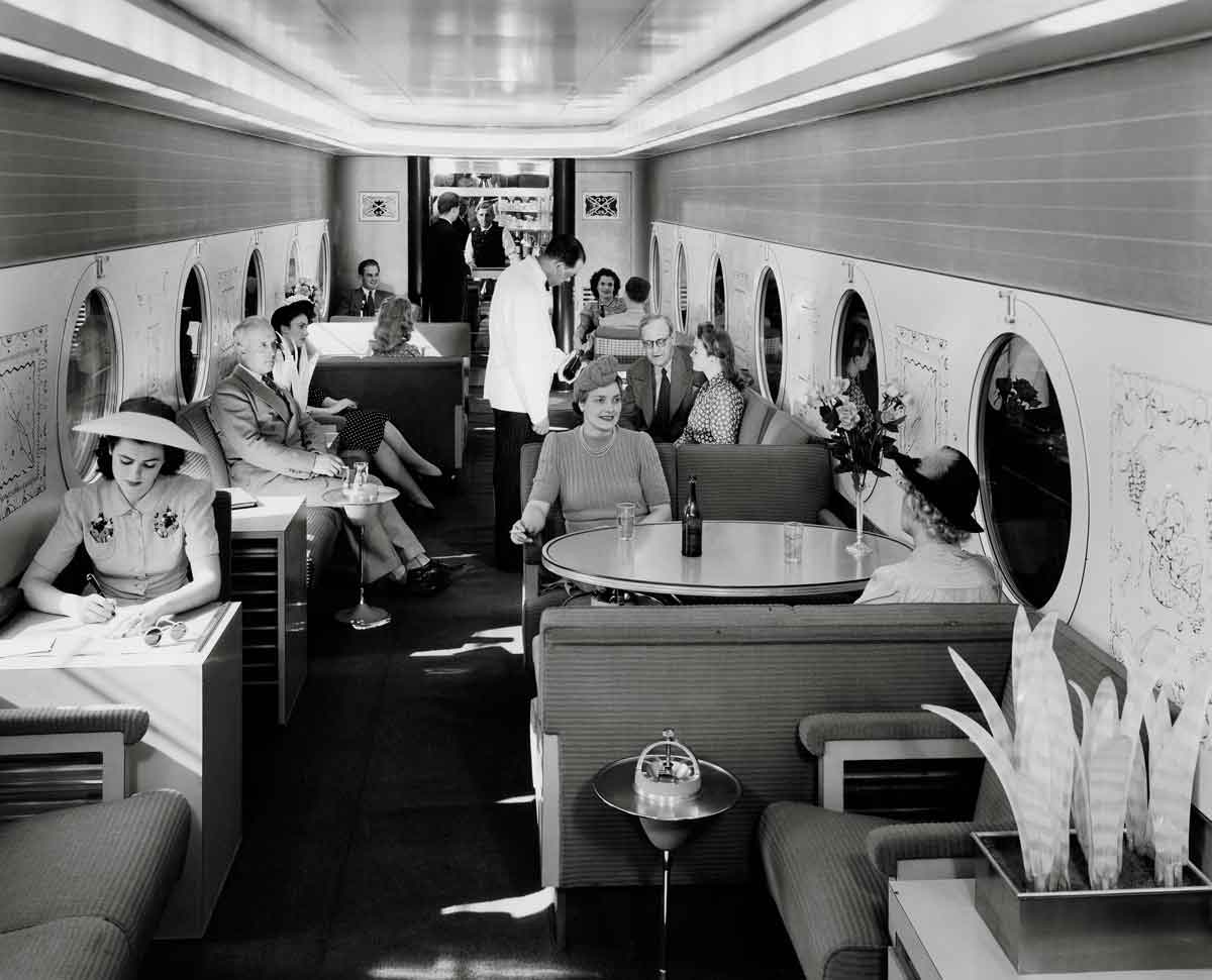 People sit inside railroad lounge car