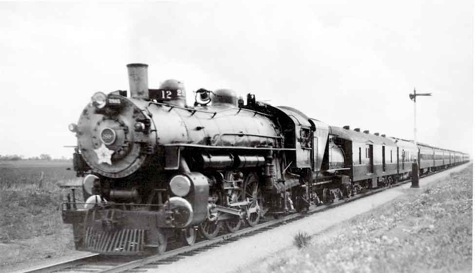 Steam locomotive with passenger train by semaphore signal