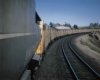 Yellow passenger train on curve as seen from lead locomotive