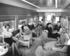 People in passenger train lounge car