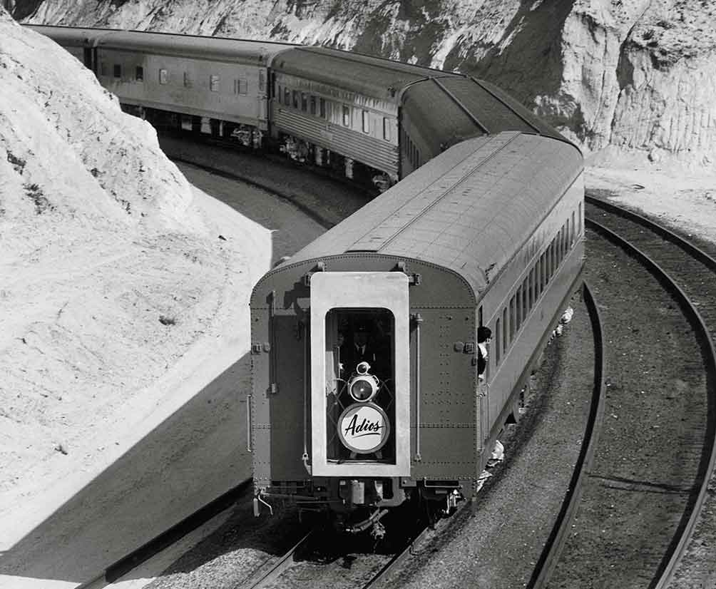 Sign reading Adios on rear of passenger train