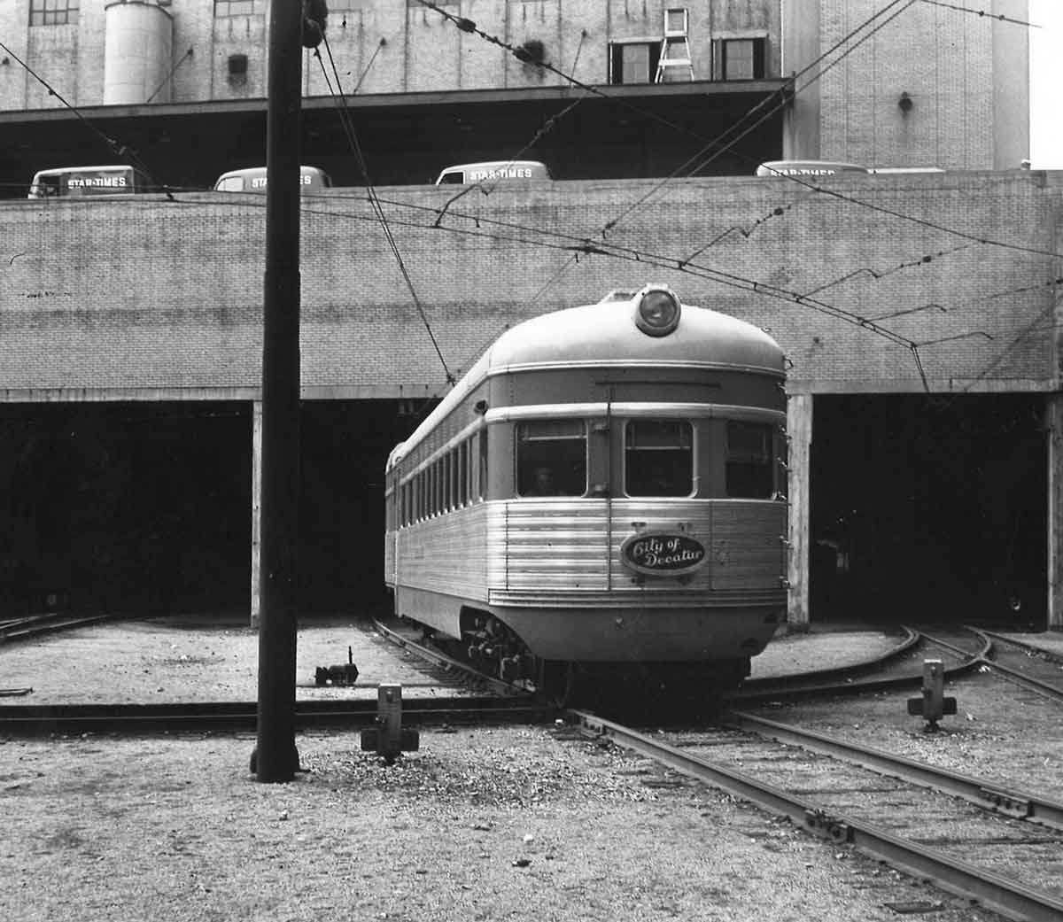 A black and white photo of a passenger car