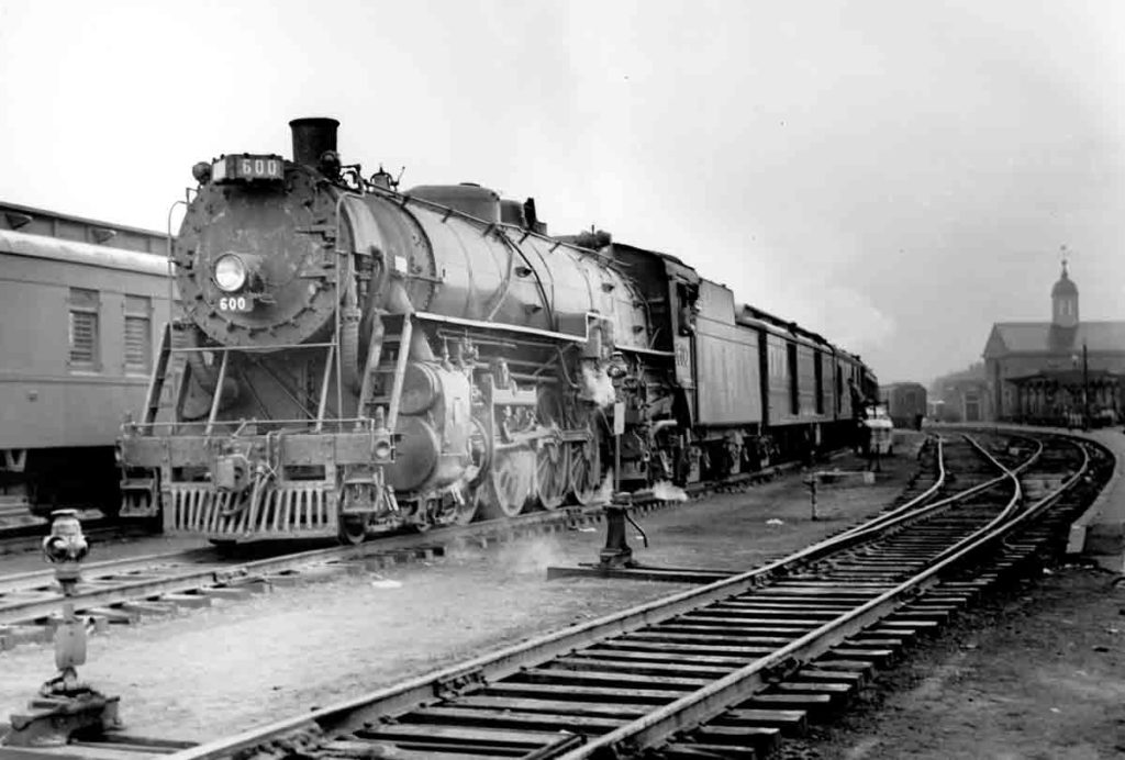 Steam locomotive with passenger train at station