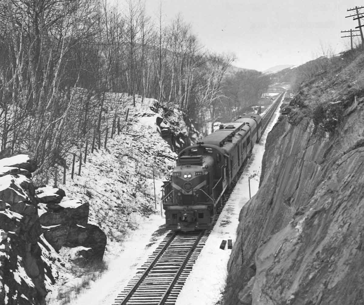 Diesel powered passenger train in rock cut
