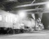 Steam powered passenger train under train shed