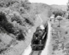 Steam locomotive with passenger train viewed from overhead