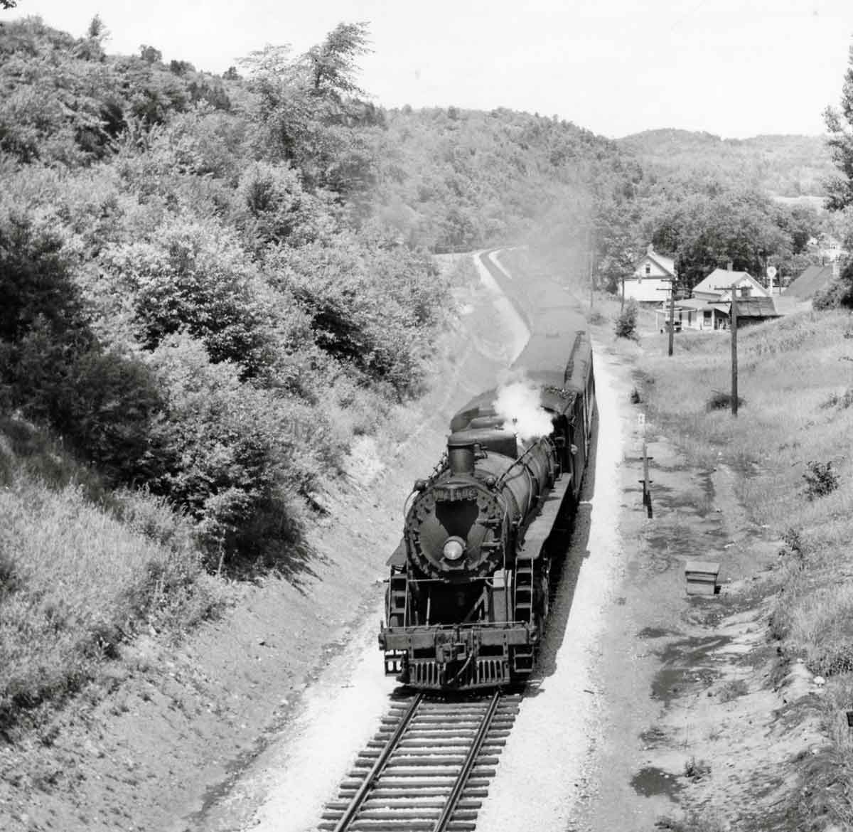 Steam locomotive with passenger train viewed from overhead