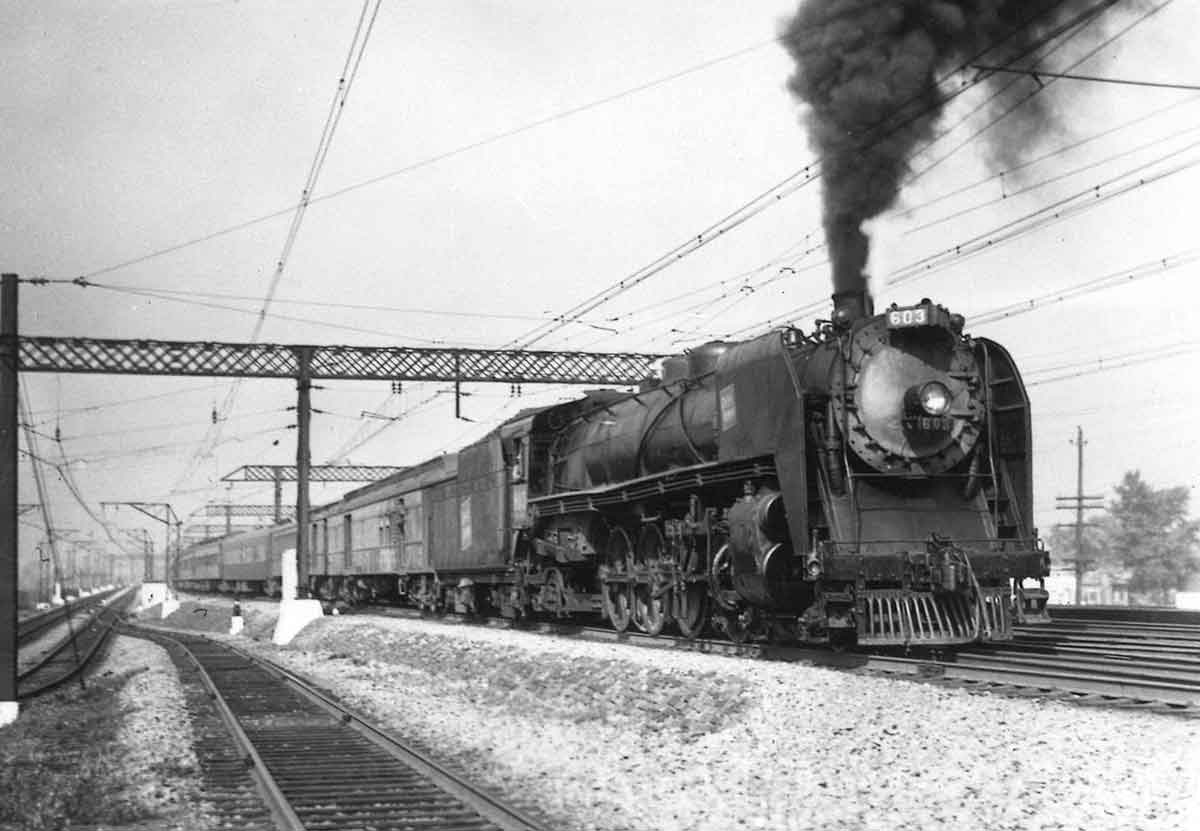 Steam locomotive with passenger train under catenary