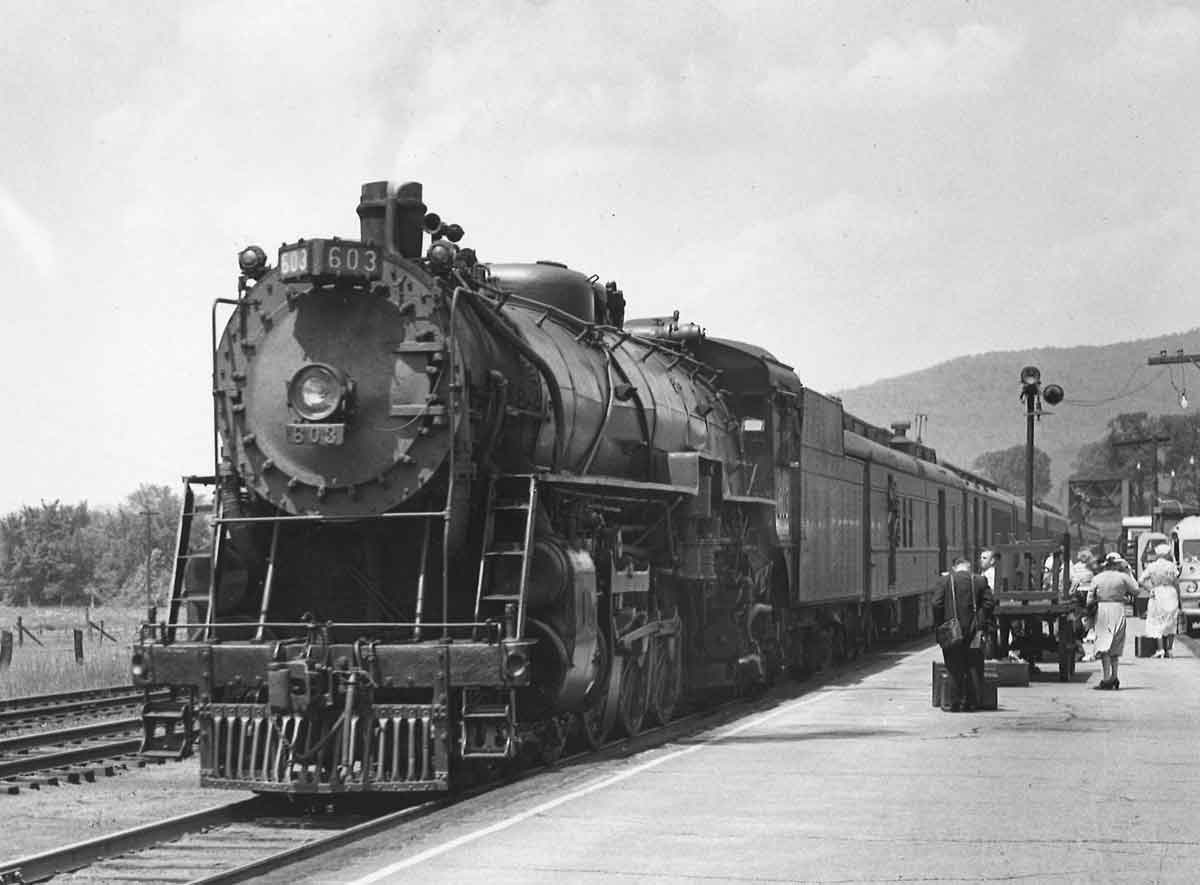 Steam locomotive with passenger train at station