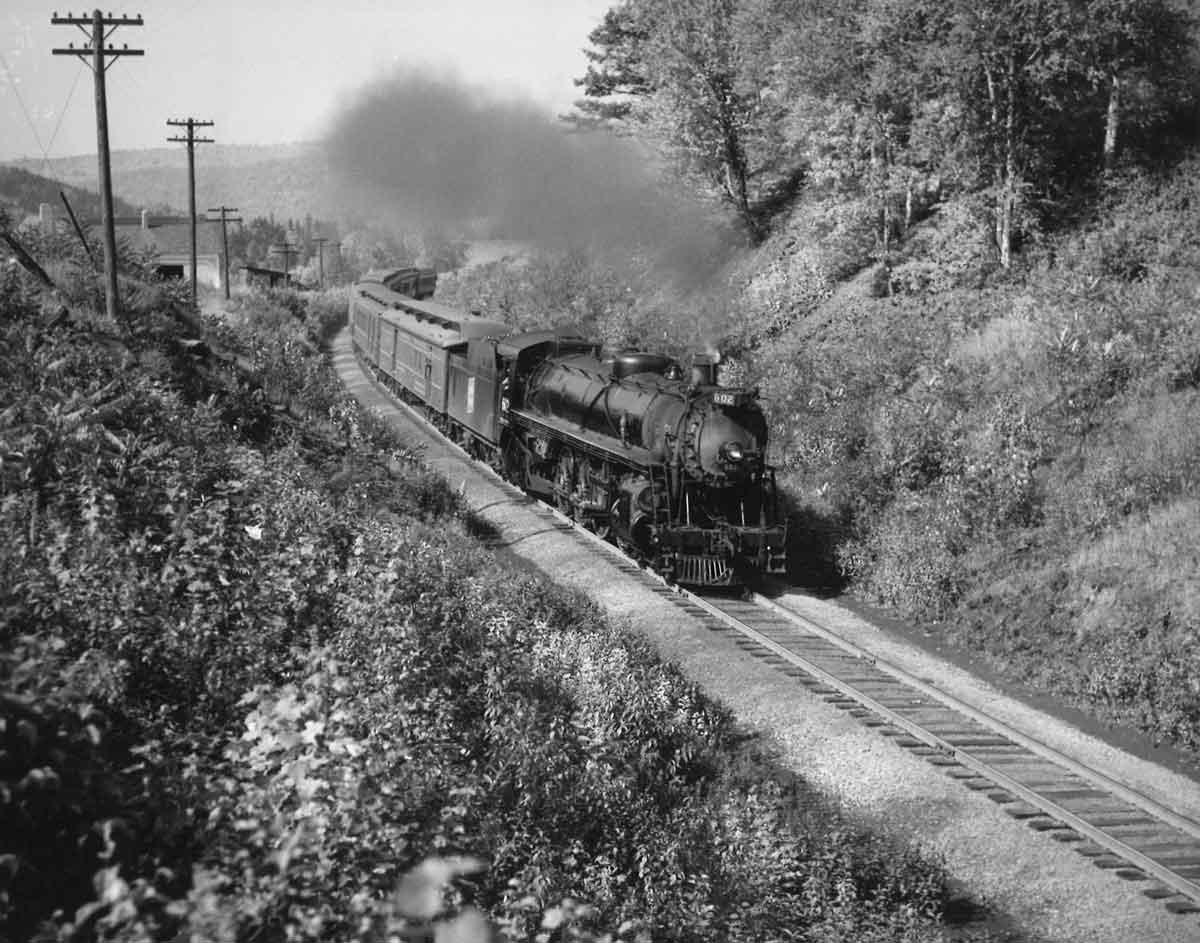 Steam locomotive with passenger train on curve