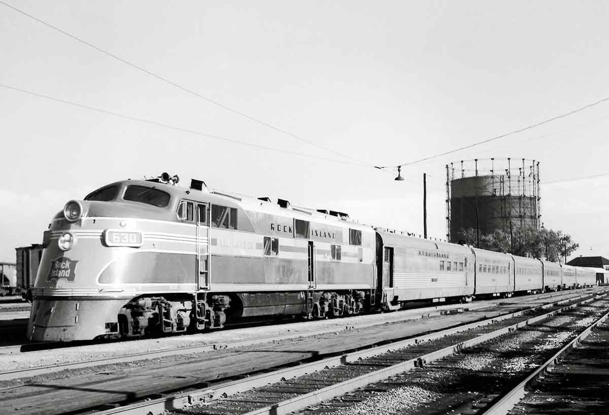 A black and white photo of a train passing by