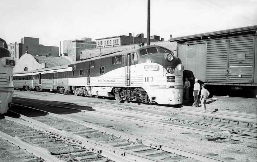 Two people standing outside a train 