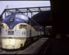 A blue and yellow train traveling through a tunnel