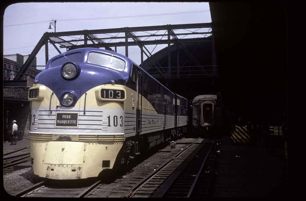 A blue and yellow train traveling through a tunnel