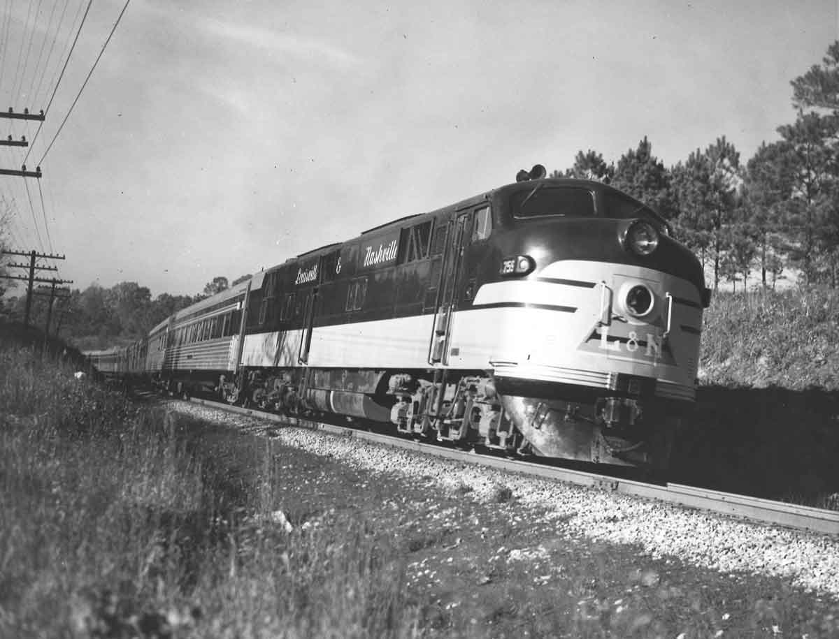 A black and white train moving down the track