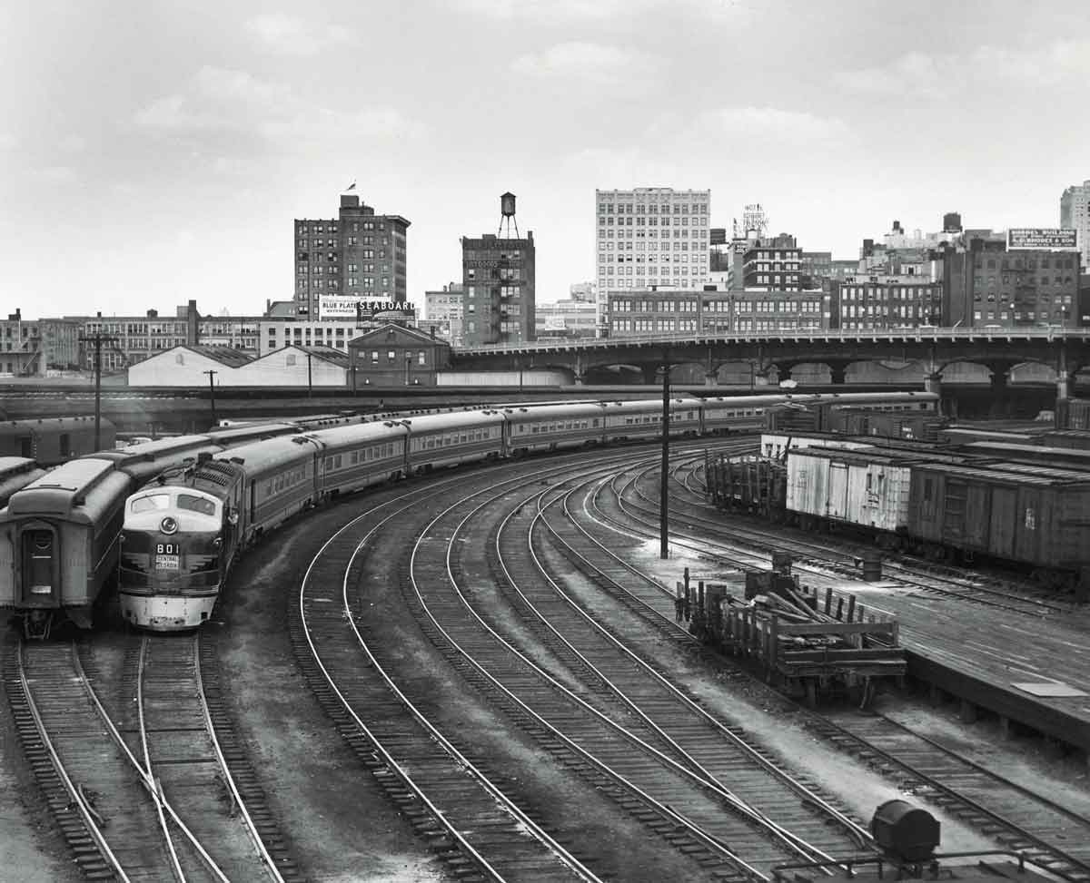 Diesel powered passenger train on curve in urban area