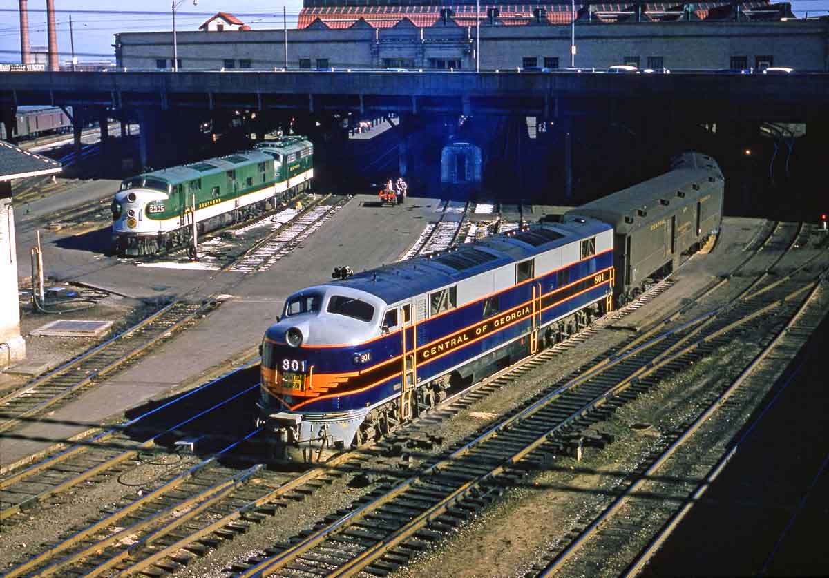 Diesel-powered passenger trains exiting elevated station