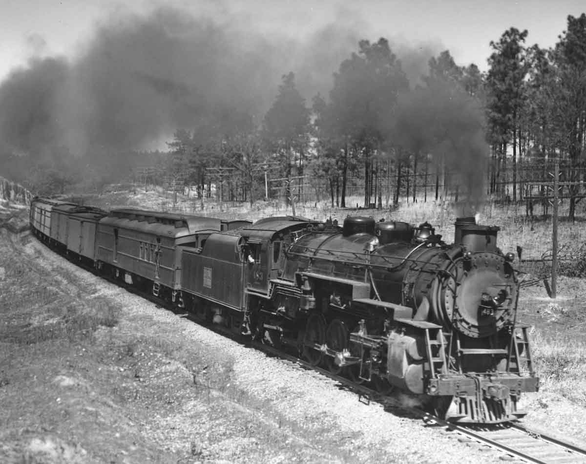 Steam locomotive with passenger train at speed on curve