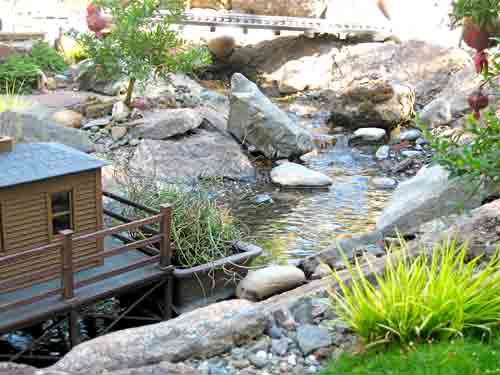 pondless water feature with model house nearby