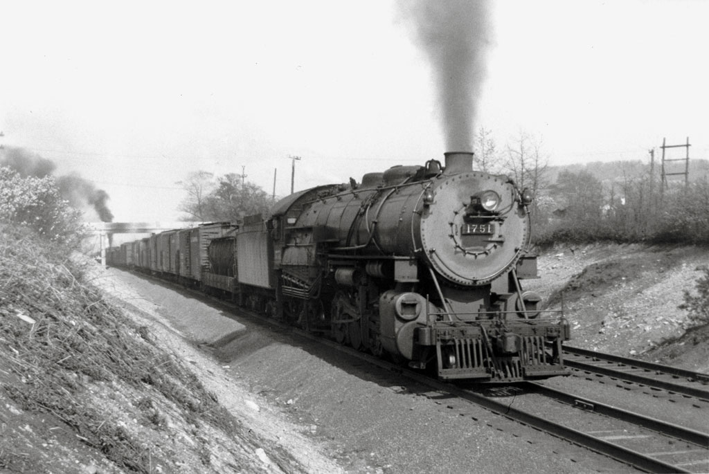 A train passing beneath a bridge