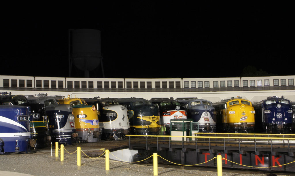 Diesel trains sitting around a turntable