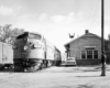 Passenger train by wooden station