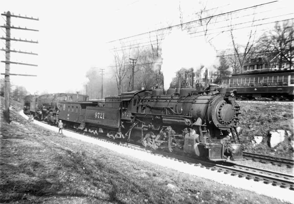 Smoking steam Missouri Pacific locomotives with freight train