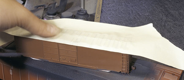 Roof weathering. Apply tape to the airbrushed roof and rip off to expose patches of silver. Repeat as necessary.