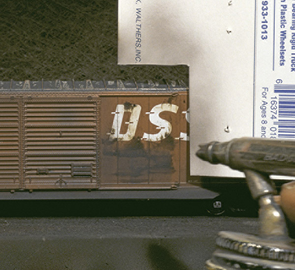 Paint a straight edge. Use an index card for better control while airbrushing. This is especially helpful when trying to get a straight edge, as Bob did with this rust patch.