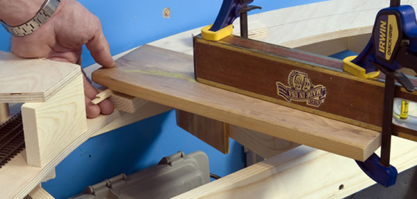 Fig. 4. Jeff put shims under one end of a level to equal the desired amount of rise from one side of the helix to the other. When the far side of the helix showed as level, the grade was correct.