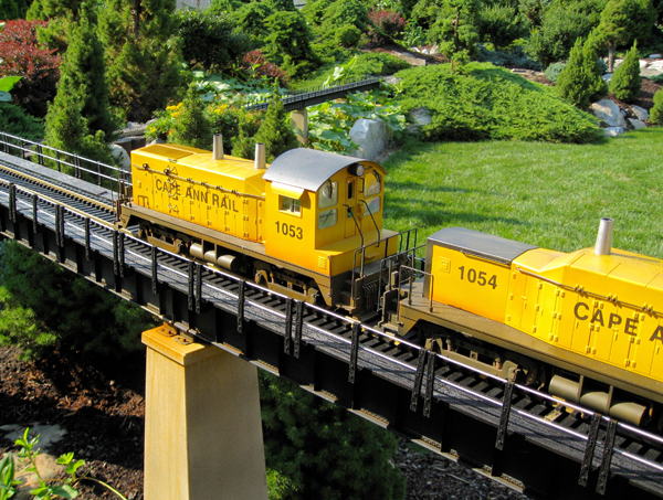yellow diesel engine crossing trestle on garden railway
