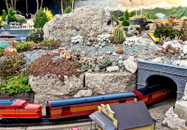 colorful train entering tunnel