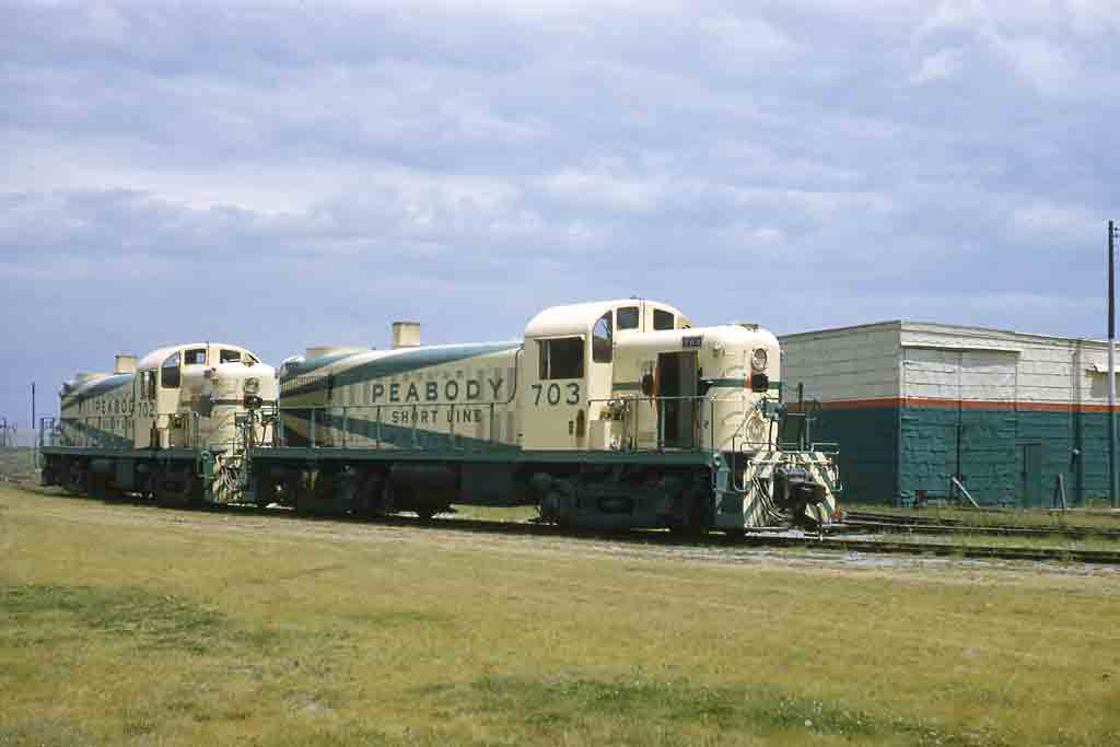 Two yellow and green diesel locomotives