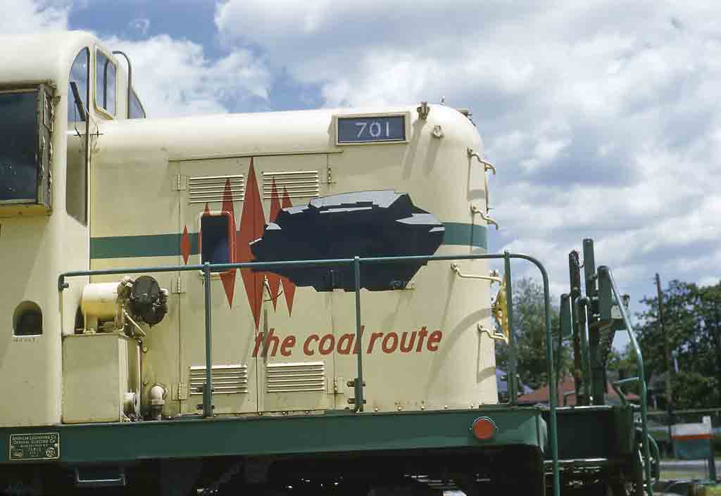 Nose of yellow diesel locomotive with coal logo
