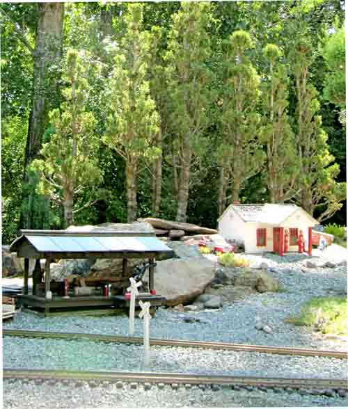 forest with station in garden railway