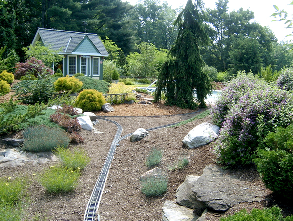 section of garden railroad with mulch