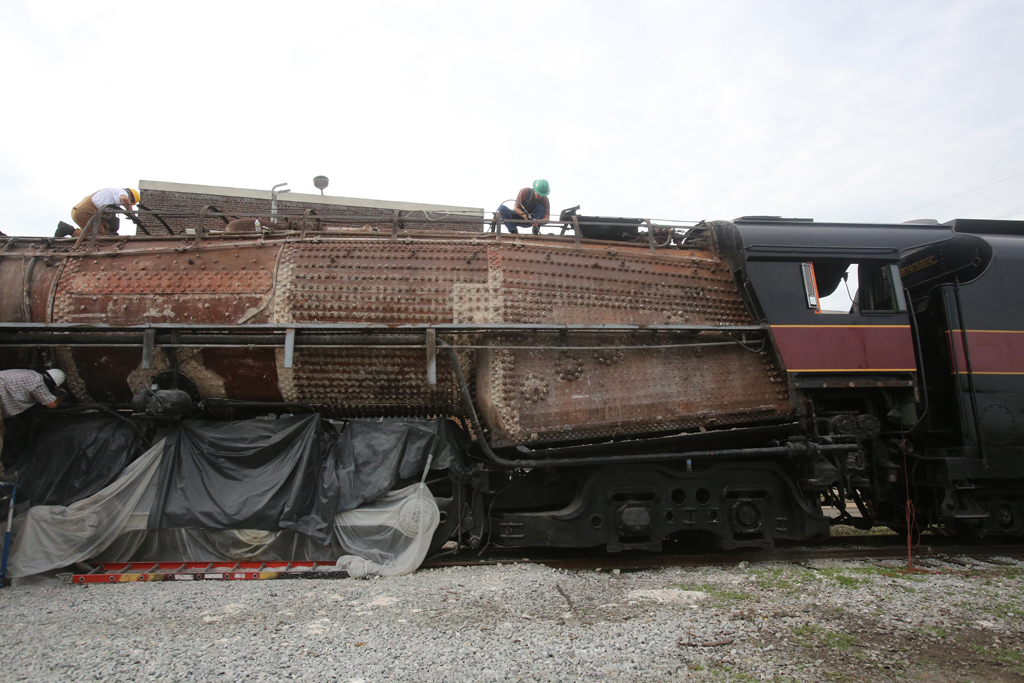 A man working on top of a train