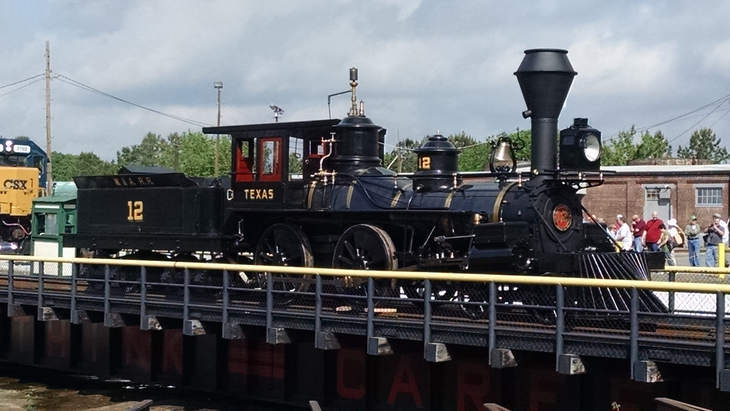 Steam locomotive from the 19 Century displayed on a turntable.