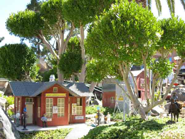 model house with tree next to it