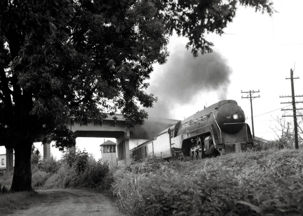 A train passing below a bridge