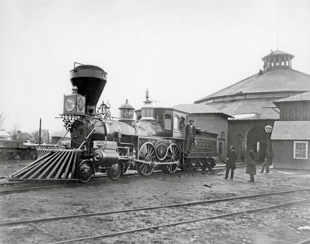 black and white photo of engine and people