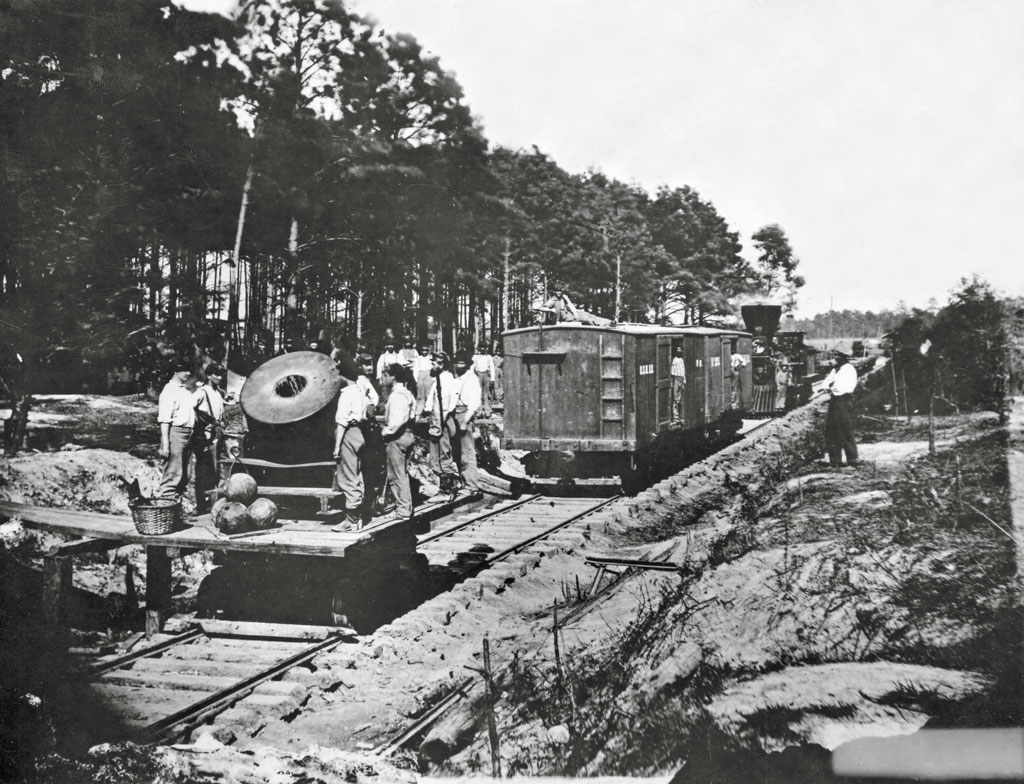 black and white photo of weapon moving on tracks