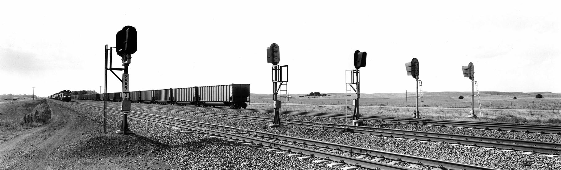 Nothing says Union Pacific Railroad quite like an ultra-busy, multi-track main line like this triple-track speedway in Lincoln County, Neb. A siding runs on a lower embankment just beyond the far track. It is likely that these tracks were built atop the same alignment laid out by the surveyors of the original transcontinental line in the 1860s. At the time of construction, a simple low embankment was scraped up and out of the surrounding prairie, and light rail was spiked to cottonwood ties, a far cry from the deep rock ballast, concrete ties, and heavy welded rail of today.
