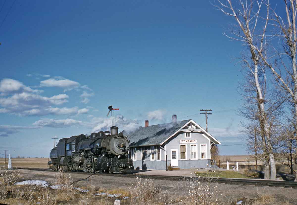 A train passing by a building