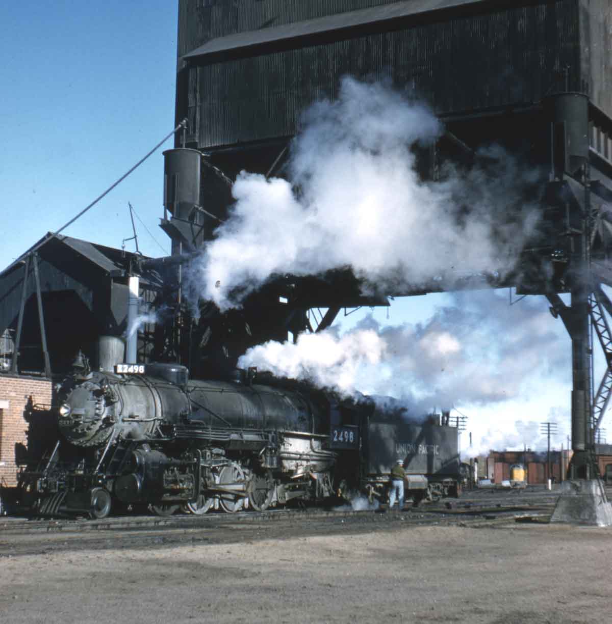 A train passing beneath a coal chute