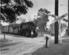 Man waves in front of steam locomotive